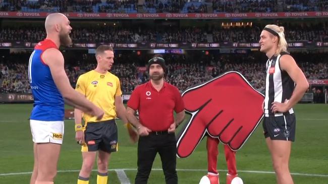 The coin was tossed in front of a Coles emblem. Photo: Fox Footy.