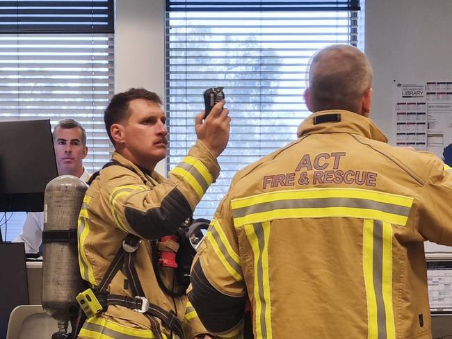 CANBERRA, AUSTRALIA - APRIL 17: The Press Gallery was evacuated after a fire in the roof, staff wait outside Parliament House in Canberra. Picture: NCA NewsWire / Martin Ollman