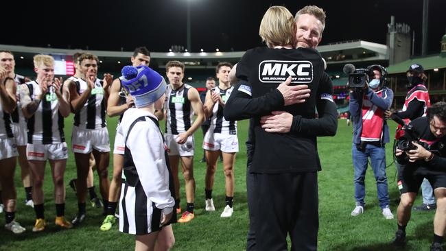 Magpies head coach Nathan Buckley celebrates victory with sons Ayce and Jett Buckley. Picture: Matt King