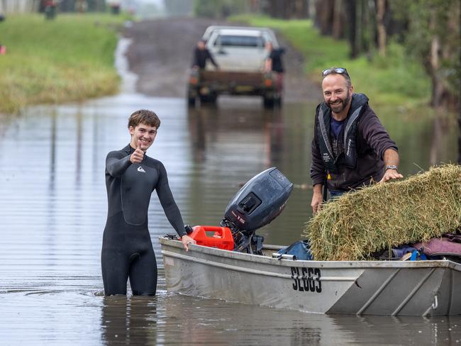 The floods have closed the roads into around Taree neighbours are using boats to cross roads and bring supplies to people trapped by the flood waters.Picture Thomas Lisson