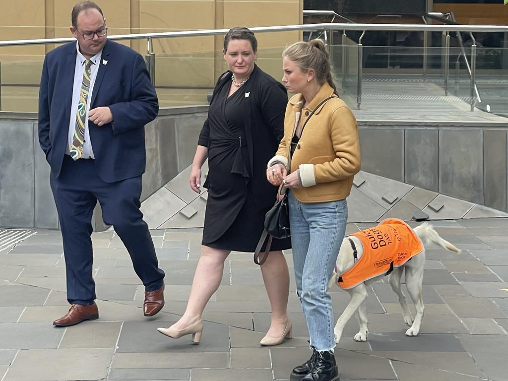 Katrina Munting (centre) and former Australian of the Year Grace Tame (right) outside the Supreme Court of Tasmania. Ms Munting is suing her former science teacher who sexually abused her as a teenager, along with his employer, the state of Tasmania. Picture: Amber Wilson