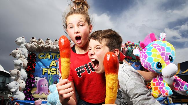 The Royal Hobart Show in recent years. Siblings Beatrice 11 and Ethan Chelkowski, 10 of Dodges Ferry enjoy a dagwood dog at the Royal Hobart Show. Picture: Zak Simmonds