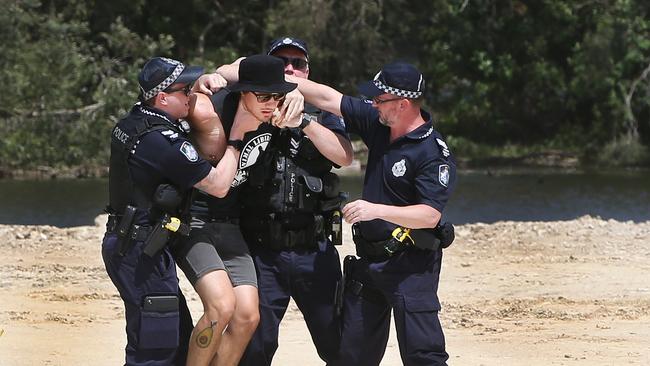 Black Swan Lake protest at Bundall goes to another level, with protesters chaining themselves to the fence and then getting themselves arrested after running onto the worksite and stopping the trucks. Protester known only as 