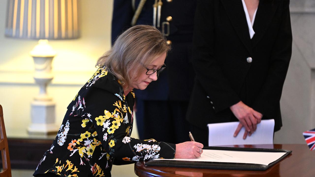 Yvette D’Ath signs after swearing-in as the Queensland Attorney-General at Government House in Brisbane. Picture: Dan Peled / NCA NewsWire