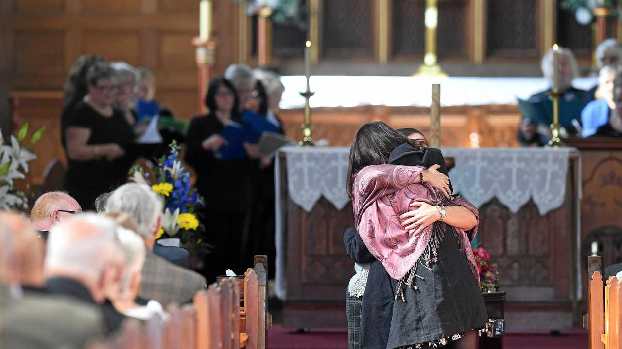 Mourners hug at the funeral service for Geoffrey Cawley, held at St Andrew's Anglican Church in Lismore. Picture: Marc Stapelberg