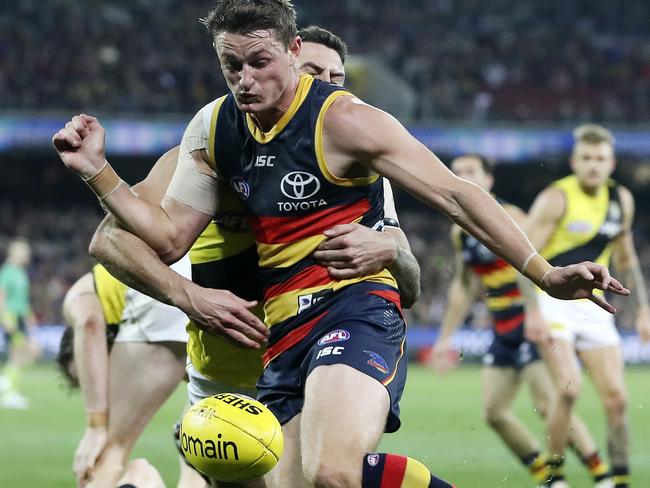 Matt Crouch tries to get a kick away under intense Richmond pressure. Picture: Sarah Reed