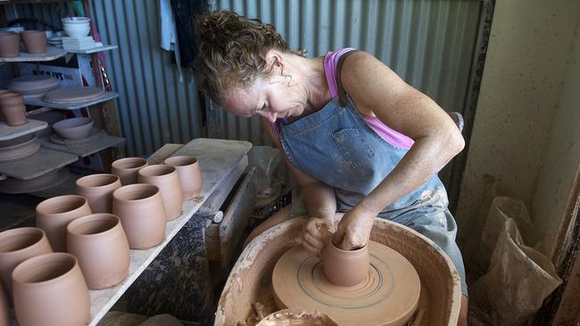 Potter Brooke Clunie at the wheel in her studio.