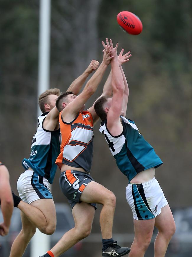 RWWW Giants player Mason Collins is sandwiched between two CDHBU opponents Thomas Webb and Deaken Clancy. Picture: Yuri Kouzmin