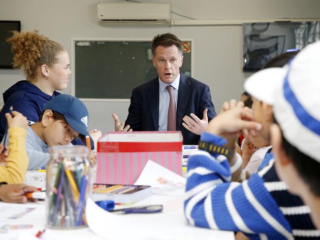 SYDNEY, AUSTRALIA - NewsWire Photos OCTOBER 4, 2024:  NSW Premier Chris Minns sits with kids doing School holiday craft class while visiting  Glebe-Leichhardt PCYC ahead of ahead of the NSW GovernmentÃ¢â¬â¢s Social Media Summit next week. Picture: NewsWire / John Appleyard