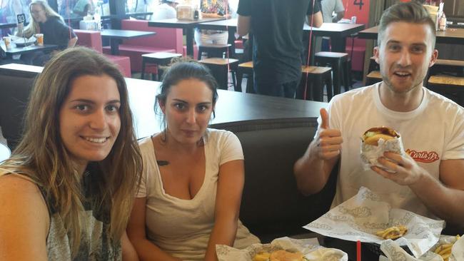 Brianne Durso, of The Entrance, Shaye Lawson, of Shelly Beach, and Tom Casey, of Wamberal, give the thumbs-up to Carl's Jr's burgers on the opening day.