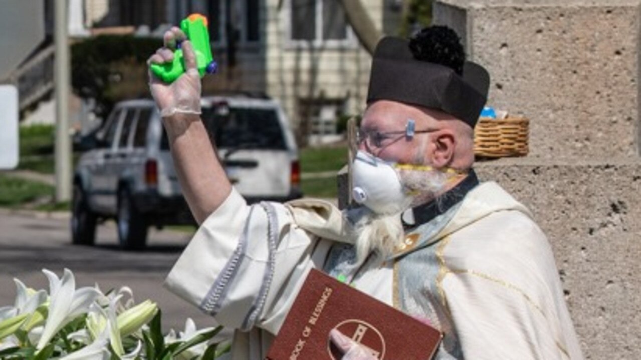 Father Tim Pelc blessed dozens of parishioners who were safely distanced from him by staying in their cars.