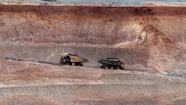 Two earth movers pass each other while retrieving copper mineral deposits from the base of Oz Minerals’ Prominent Hill open pit mine in South Australia. Picture: Carla Gottgens/Bloomberg via Getty Images