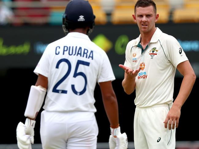 Australia's paceman Josh Hazlewood (R) reacts after bowling to Indian batsman Cheteshwar Pujara on day two of the fourth cricket Test match between Australia and India at The Gabba in Brisbane on January 16, 2021. (Photo by Patrick HAMILTON / AFP) / --IMAGE RESTRICTED TO EDITORIAL USE - STRICTLY NO COMMERCIAL USE--