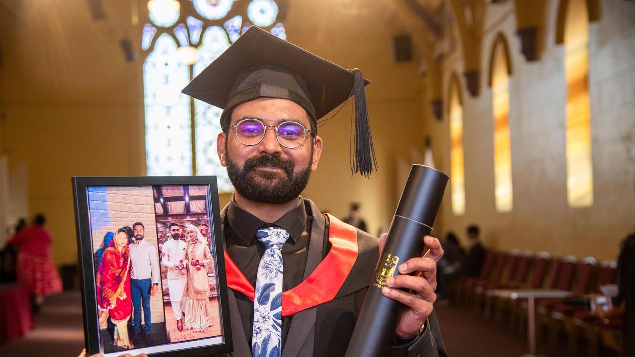 Holding a photograph of his wife, Bashir, who was unable to attend the graduation, Muhammad Farooq Bashir, graduated with a Master of Information Systems. UniSQ graduation ceremony at Empire Theatre. Wednesday, June 28, 2023