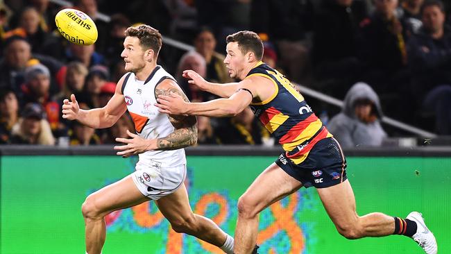 Luke Brown puts pressure on Giant Daniel Lloyd in Adelaide’s Round 12 victory at Adelaide Oval. Picture: Mark Brake/Getty Images.