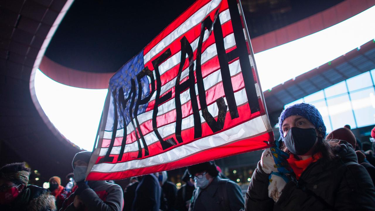 Demonstrators hold a banner calling for impeachment of US President Donald Trump during a protest outside the Barclays Center in Brooklyn, New York. Picture: Kena Betancur / AFP.