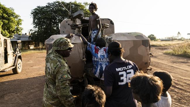 Private Misman Kris shows one of the vehicles to children of Wudikapildyerr. Picture: Dylan Robinson