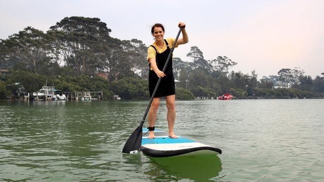 Kate Waterson is hoping the tourist trade will return and people will come and spend money on things like stand up paddle boarding tours that her business offers at Mossy Point. Picture: Toby Zerna