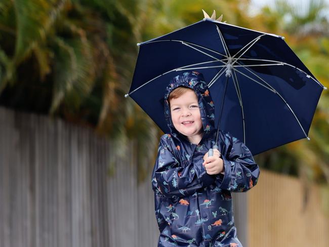 The start of summer has seen rainy weather return to Far North Queensland. Cairns youngster Noah Millard, 4, enjoys the return of the wet weather, dressing up in his raincoat and gumboots, and jumping into rain puddles outside his Smithfield home. Picture: Brendan Radke