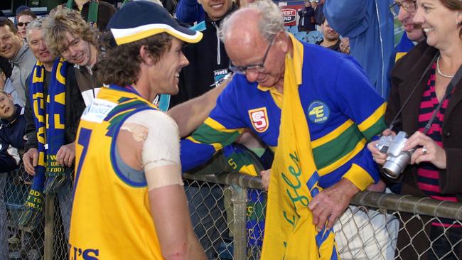 Former Woodville-West Torrens player and current chief executive Luke Powell hugs club stalwart Ernie Wenske after the 2006 grand final win. Picture: Supplied