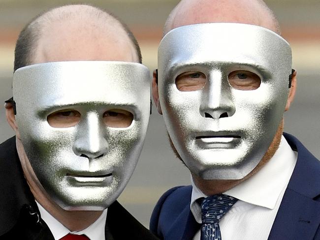 Masked brothers known as 'A' and 'B' pose for a photograph outside the Supreme Court in Adelaide on Monday, July 1, 2019. The Court of Criminal Appeal rejected convicted paedophile Vivian Deboo's bid to serve his sentence on home detention. (AAP Image/Sam Wundke) NO ARCHIVING