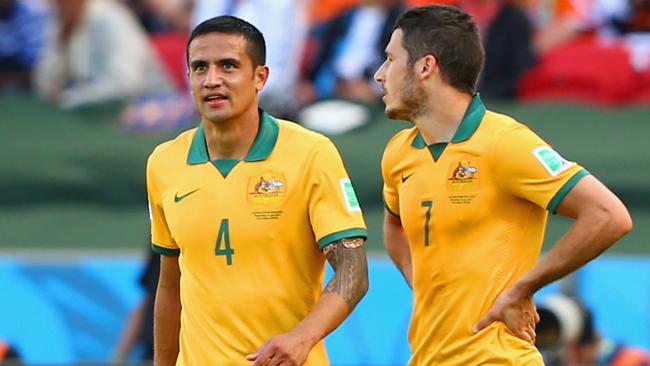 PORTO ALEGRE, BRAZIL - JUNE 18: Tim Cahill of Australia reacts after receiving a yellow card as teammates Mathew Leckie looks on during the 2014 FIFA World Cup Brazil Group B match between Australia and Netherlands at Estadio Beira-Rio on June 18, 2014 in Porto Alegre, Brazil. (Photo by Cameron Spencer/Getty Images)