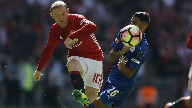 Manchester United's Wayne Rooney (L) and Leicester's Riyad Mahrez challenge for the ball.