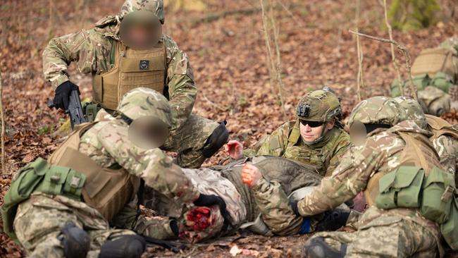 Using a simulated casualty, an Australian Army soldier from the 1st Health Battalion oversees medical training during the first rotation of Operation Kudu in the UK. Picture: Cpl Jonathan Goedhart