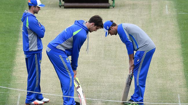 Callum Ferguson, Mitchell Marsh and Joe Burns inspect the pitch.