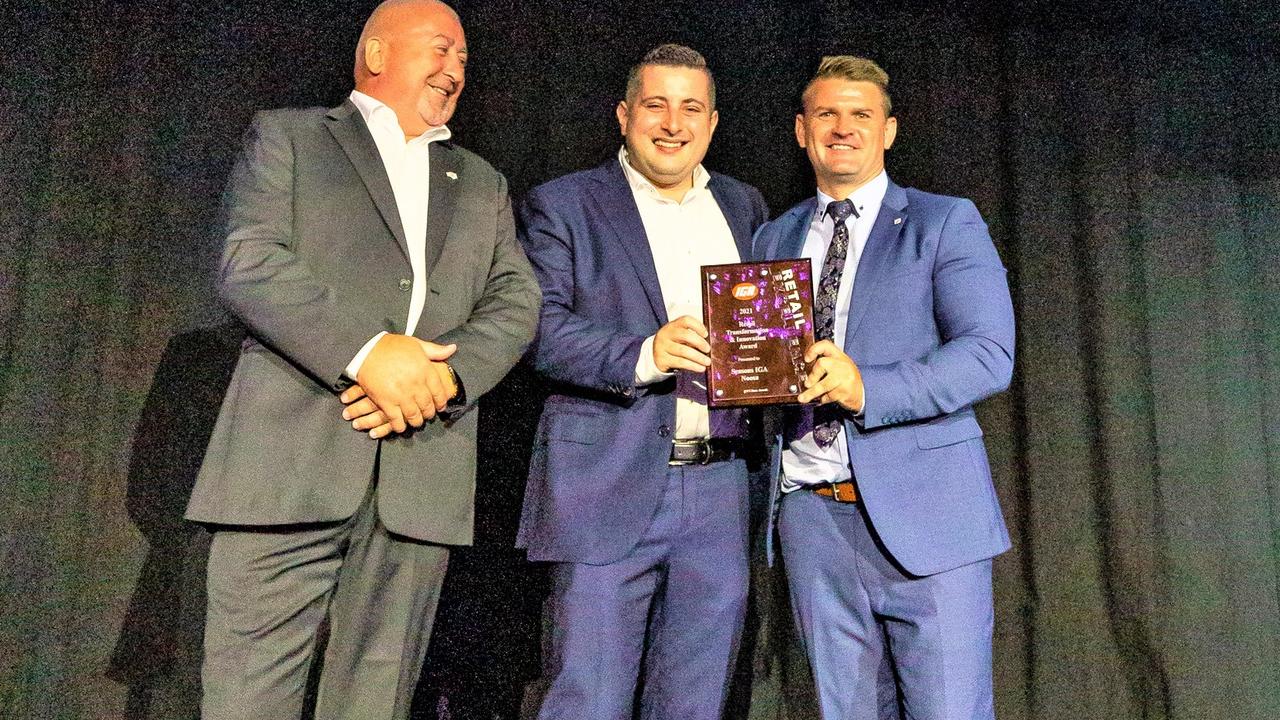 IGA Queensland State Board Chair Frank Spanos, middle, and Roy Leisk of Metcash Food present Greg Weiss, right, with his award.