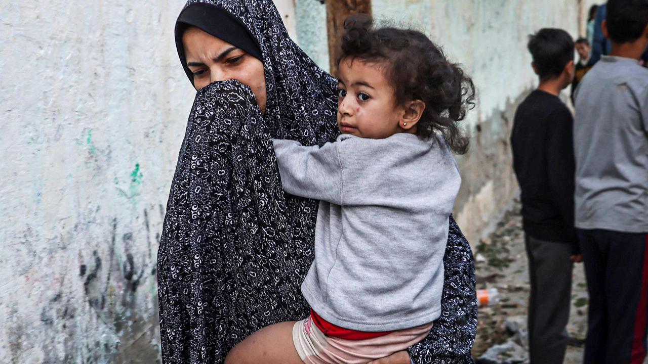 A woman holding a child flees after an Israeli strike in Rafah, in southern Gaza. Picture: Mohammed Abed/AFP