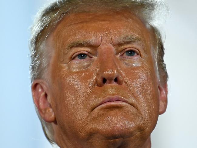 TOPSHOT - US President Donald Trump looks on after delivering his acceptance speech for the Republican Party nomination for reelection during the final day of the Republican National Convention at the South Lawn of the White House in Washington, DC on August 27, 2020. (Photo by Brendan Smialowski / AFP)