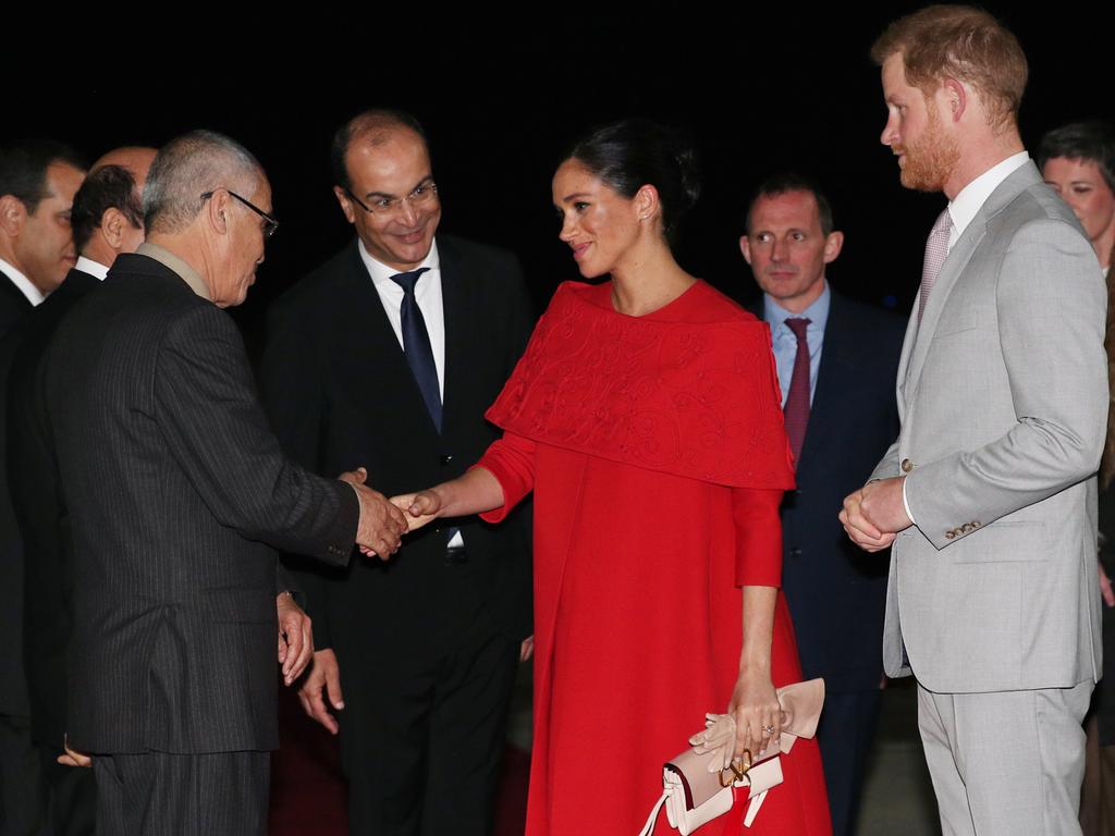 Prince Harry, Duke of Sussex and Meghan, Duchess of Sussex are welcomed by officials as they arrive at Casablanca Airport. Picture: Getty