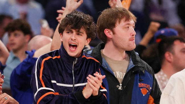 Timothee Chalamet cheers in the first quarter of the game. (Photo by AL BELLO/Getty Images via AFP)