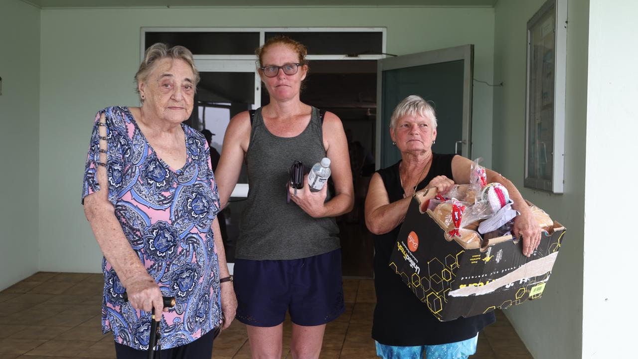 A monsoonal tropical low pressure system has brought devastating widespread flooding to North Queensland and parts of Cardwell in Far North Queensland, with over 1000 millimetres of rain recorded in some areas. Joyce Morrison, Carolyn Sheely and Bernice Schubert pick up some essential items from the community hub set up by Cassowary Coast Council at the Cardwell Hall. Picture: Brendan Radke