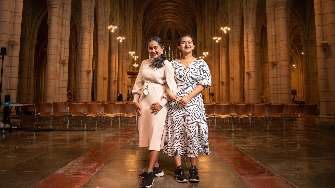 Brisbane sisters Teresa and Augnes Joy sing the national anthems of all the countries in the United Nations at Brisbane’s St John's Cathedral. Picture: Brad Fleet