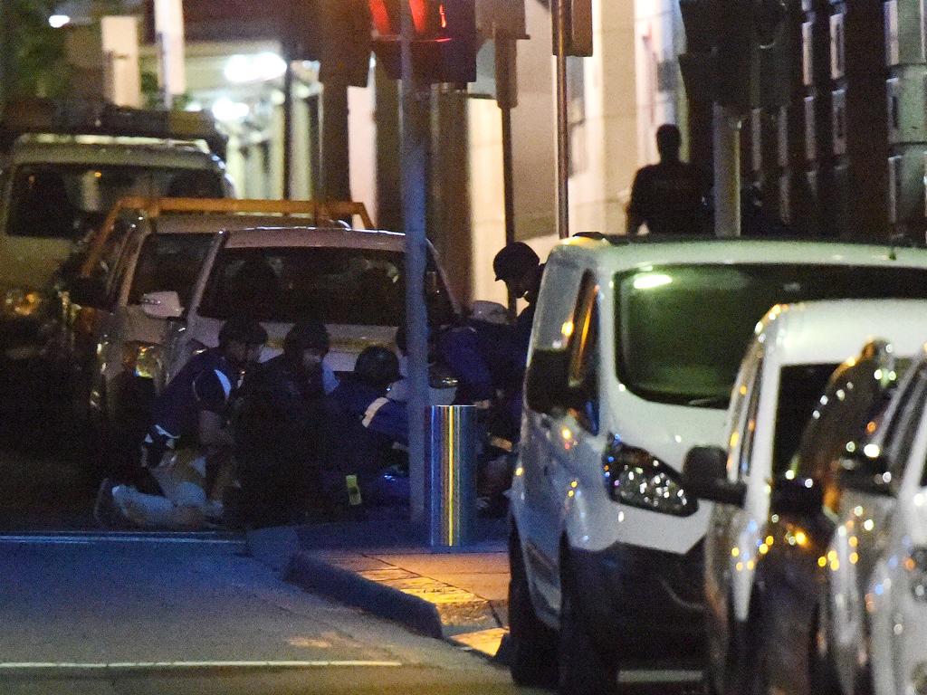 Armed police and paramedics take out injured people after the end of the siege at the Lindt cafe. Picture: Saeed Khan (AFP)