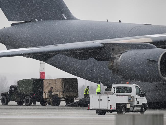 US Army soldiers and military vehicles exit a US Air Force Boeing C-17A Globemaster III transport aircraft in Rzeszow, Poland. Picture: Getty Images