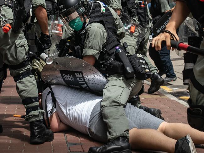 A man is detained by riot police during a demonstration in Hong Kong. Picture: Getty