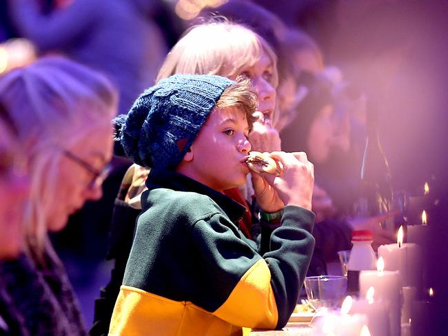 Louis Underwood, 10, of Rose Bay, tucking in at Winter Feast in Princes Wharf. Picture: SAM ROSEWARNE