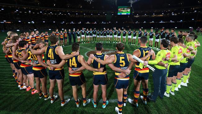 ADELAIDE, AUSTRALIA - MAY 02: A moment of silence for gender based violence during the 2024 AFL Round 08 match between the Adelaide Crows and the Port Adelaide Power at Adelaide Oval on May 02, 2024 in Adelaide, Australia. (Photo by James Elsby/AFL Photos via Getty Images)