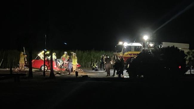 Emergency services at the scene of a fatal crash involving a ute and a truck on the Bruce Highway at Proserpine.