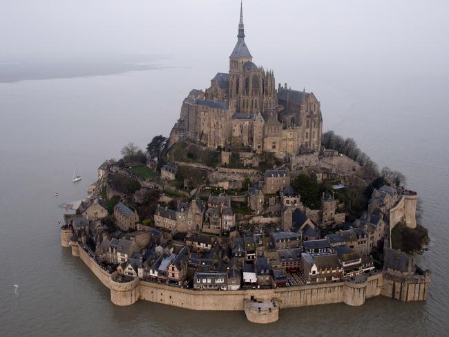 An aerial view as a high tide submerges a narrow causeway leading to the Mont Saint-Michel, on France's northern coast, Saturday, March 21, 2015. A supertide has turned France’s famed Mont Saint-Michel into an island and then retreated out of sight, delighting thousands of visitors who came to see the rare phenomenon. The so-called “tide of the century” actually happens every 18 years (AP Photo) FRANCE OUT