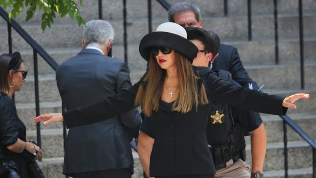 A mourner is checked by a Secret Service agent as she attends the funeral of Ivana Trump. Getty Images