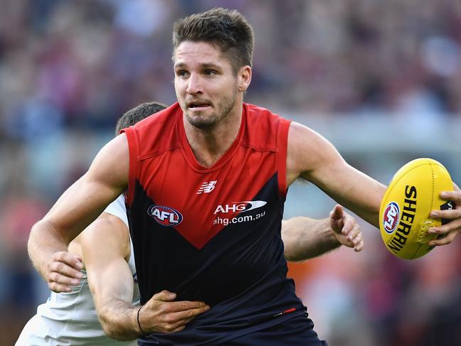 MELBOURNE, AUSTRALIA - APRIL 02:  Jesse Hogan of the Demons  is tackled by Kade Simpson of the Blues during the round two AFL match between the Melbourne Demons and the Carlton Blues at Melbourne Cricket Ground on April 2, 2017 in Melbourne, Australia.  (Photo by Quinn Rooney/Getty Images)