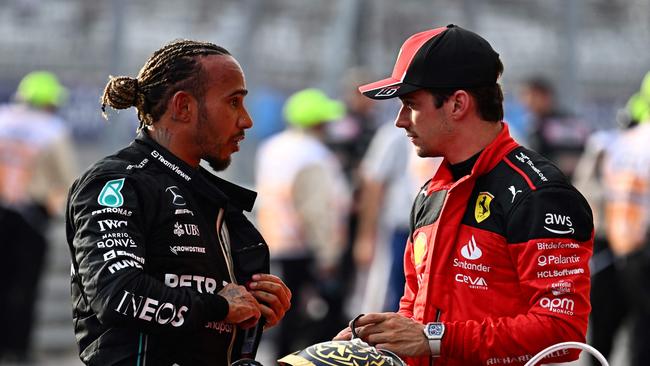 Lewis Hamilton (L) speaks with his future Ferrari teammate Charles Leclerc. (Photo by Chandan Khanna / AFP)