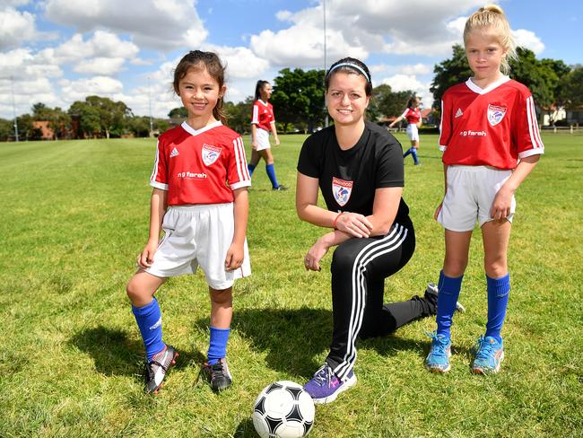 Pagewood Botany Football Club members Erin Jones, Coach Julia Chernoukha and Annabelle Bollett pose for a photo at Jellicoe Park in Pagewood, Sydney, Saturday, Nov. 11, 2017. (AAP Image/Joel Carrett)