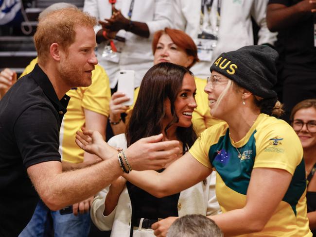 Australia’s Laura Reynell with Prince Harry and Meghan Markle. Picture: AFP