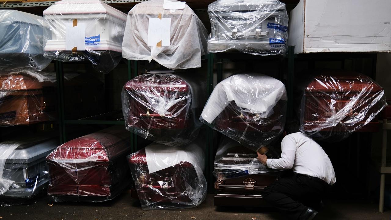 James Harvey tends to the caskets at a funeral home on April 29, 2020 in New York City. The funeral home, which serves a busy and diverse community in Queens, has been overwhelmed with the deceased from COVID-19. Picture: Spencer Platt/Getty Images/AFP.