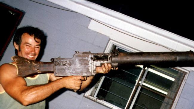 Murderer Ivan Milat in 1983, holding World War One vintage machine gun at the Buxton home of brother Alex.